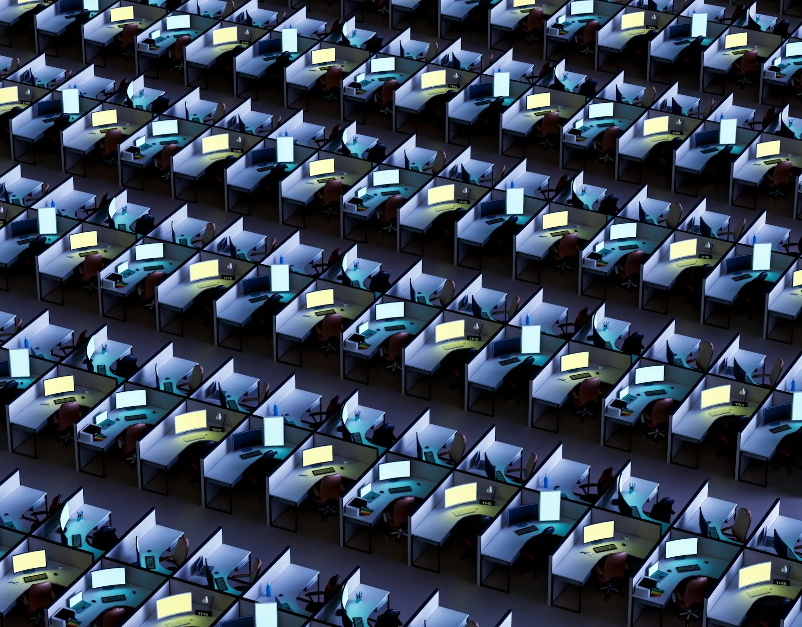 a room filled with lots of desks covered in monitors